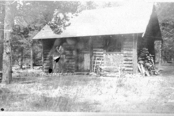 grainy old black and white photo of the Niemoth Cabin at its original location