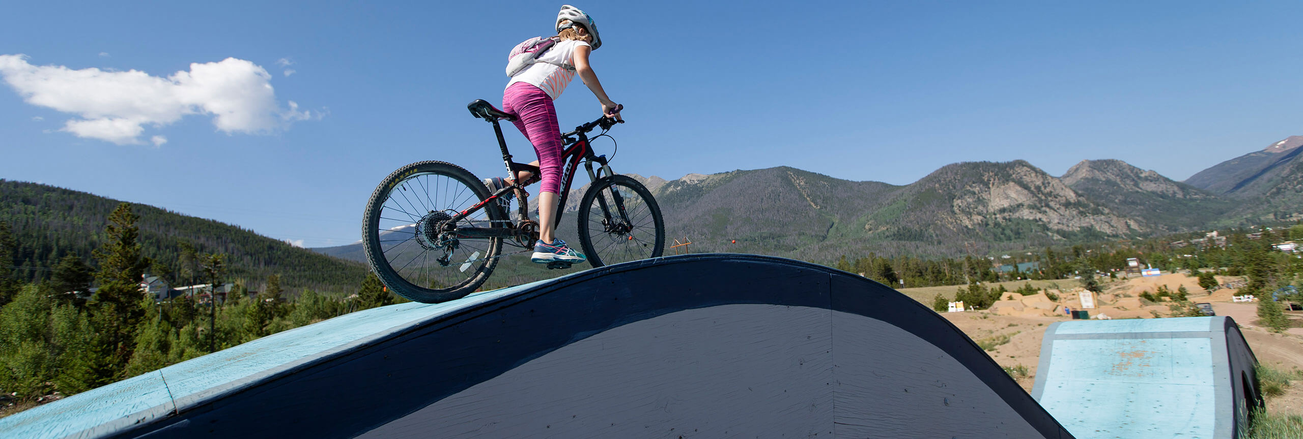 Girl on bike on rolling feature at the Frisco Bike Park