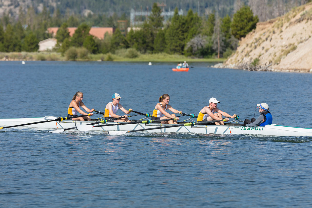 Five rowers in a row boat on Lake Dillon.