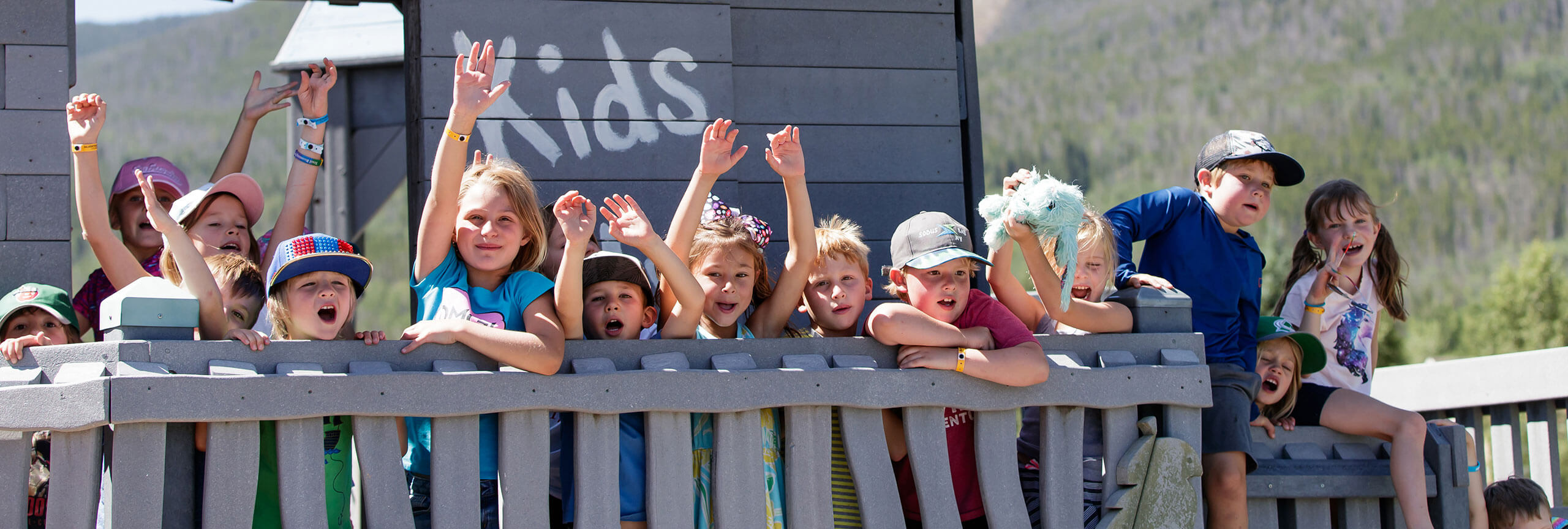 Group of kids posing on a deck.