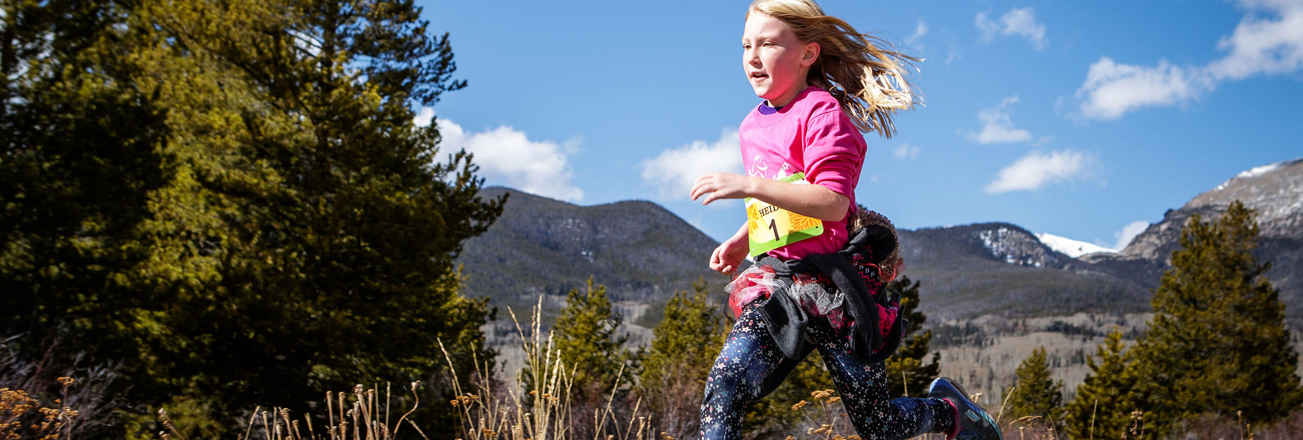 Young girl trail running.
