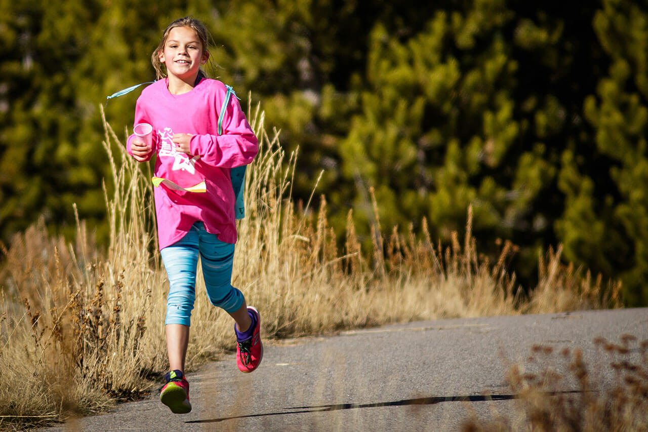Young girl running on rec path.