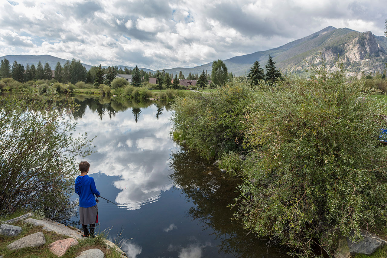 Boy fishing at Meadow Creek Park pond.