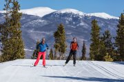 A couple skate skiing at the Frisco Nordic Center.