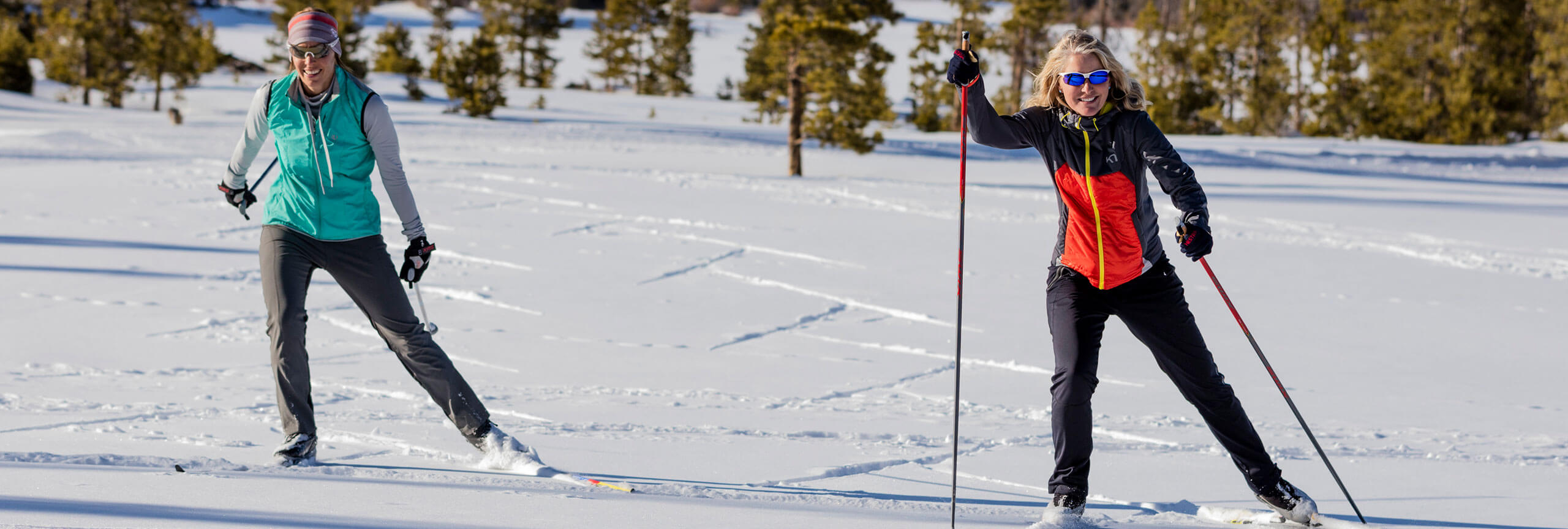 Two women skate skiing at the Frisco Nordic Center.