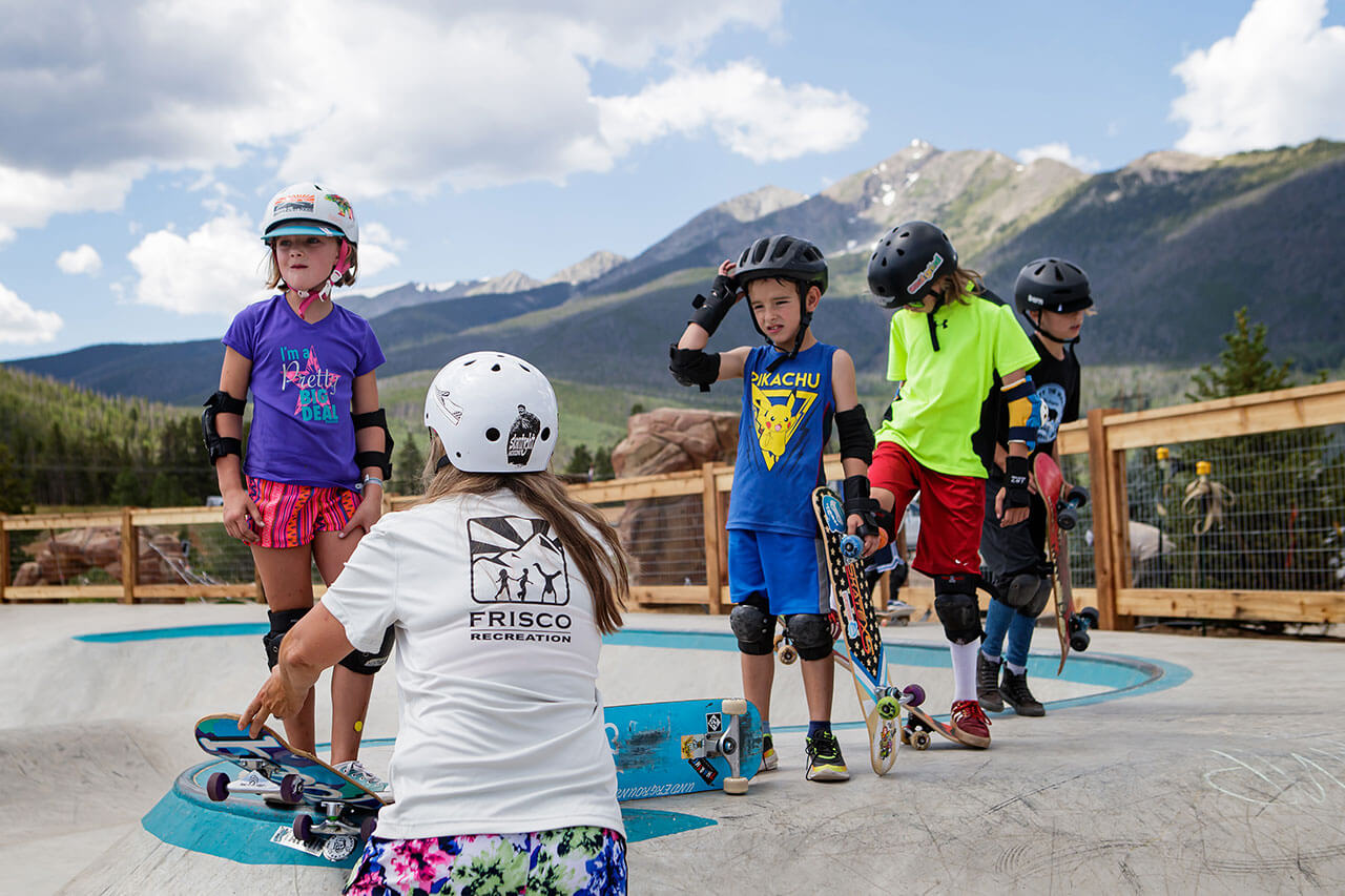 Group of kids at the Frisco Skate Park with instructor.