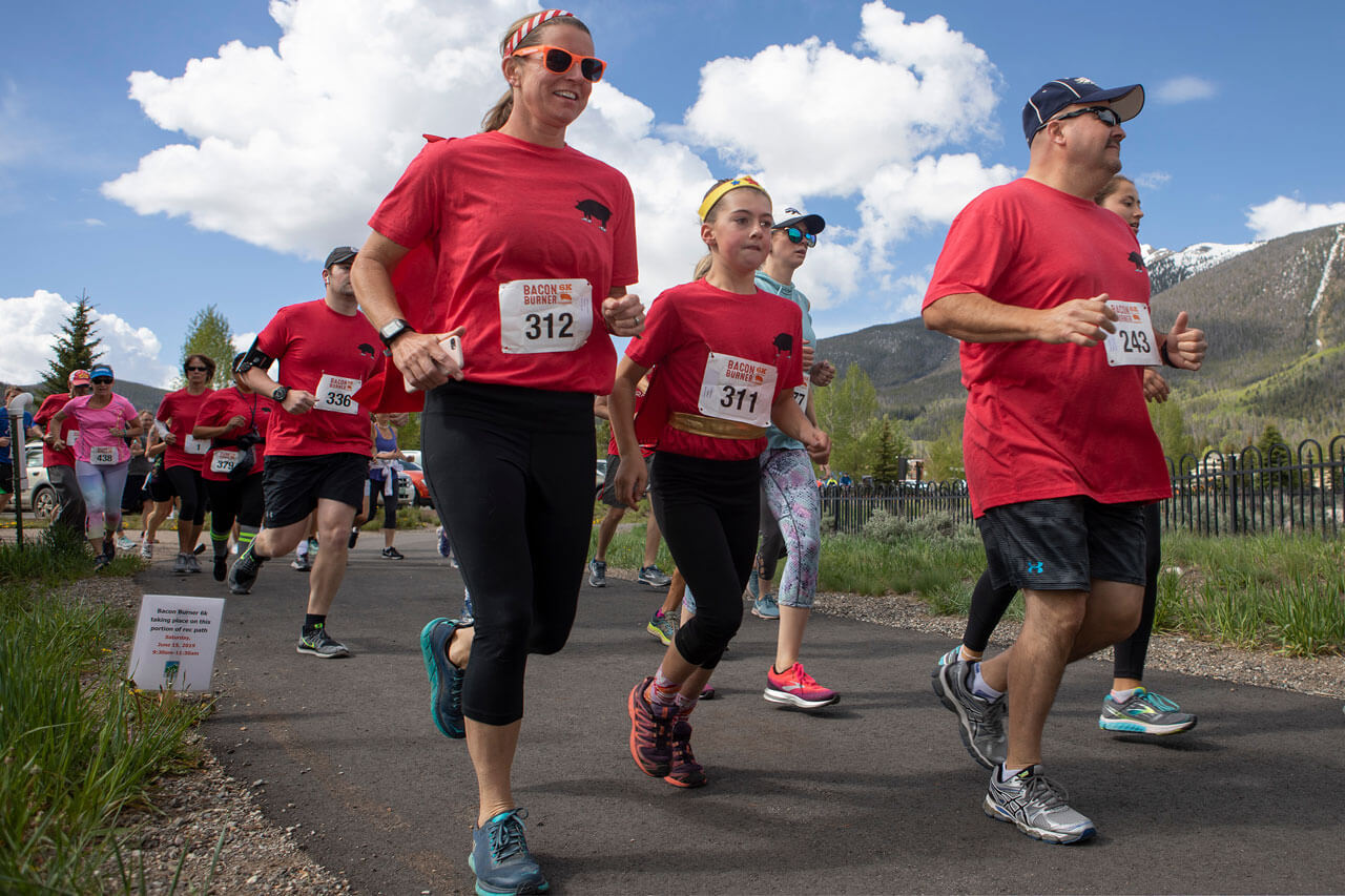 Runners wearing red t-shirts on the rec path at the Bacon Burner 5k.