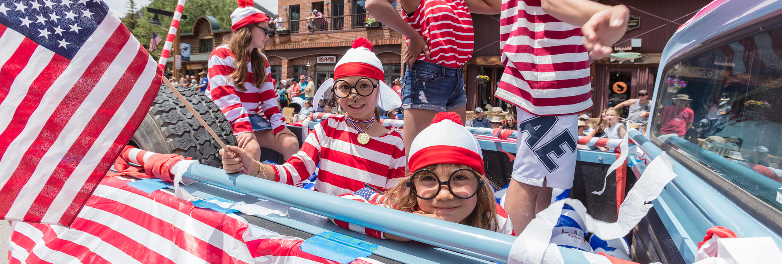 Kids dressed as Where's Waldo in truck in 4th of July Parade