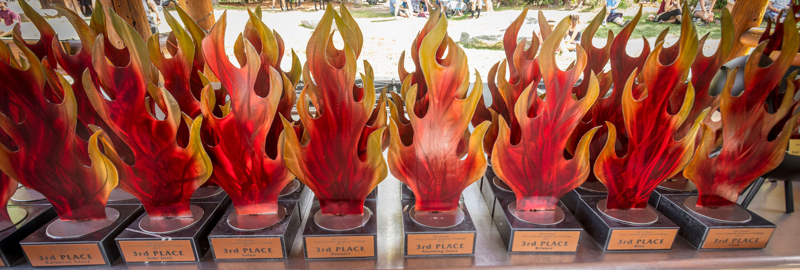 Rows of 3rd place flame-shaped trophies.