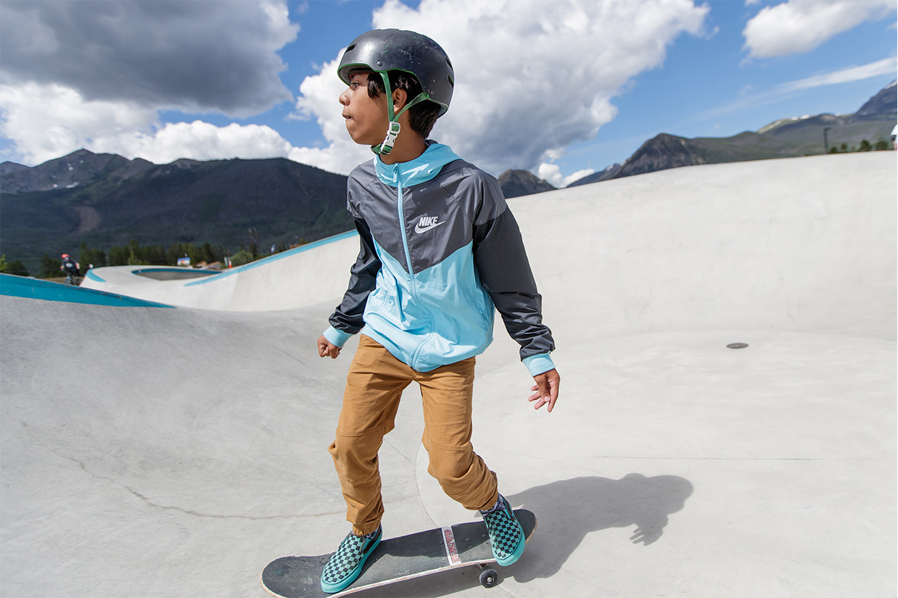 Young boy skate boarding at Frisco Skate Park.