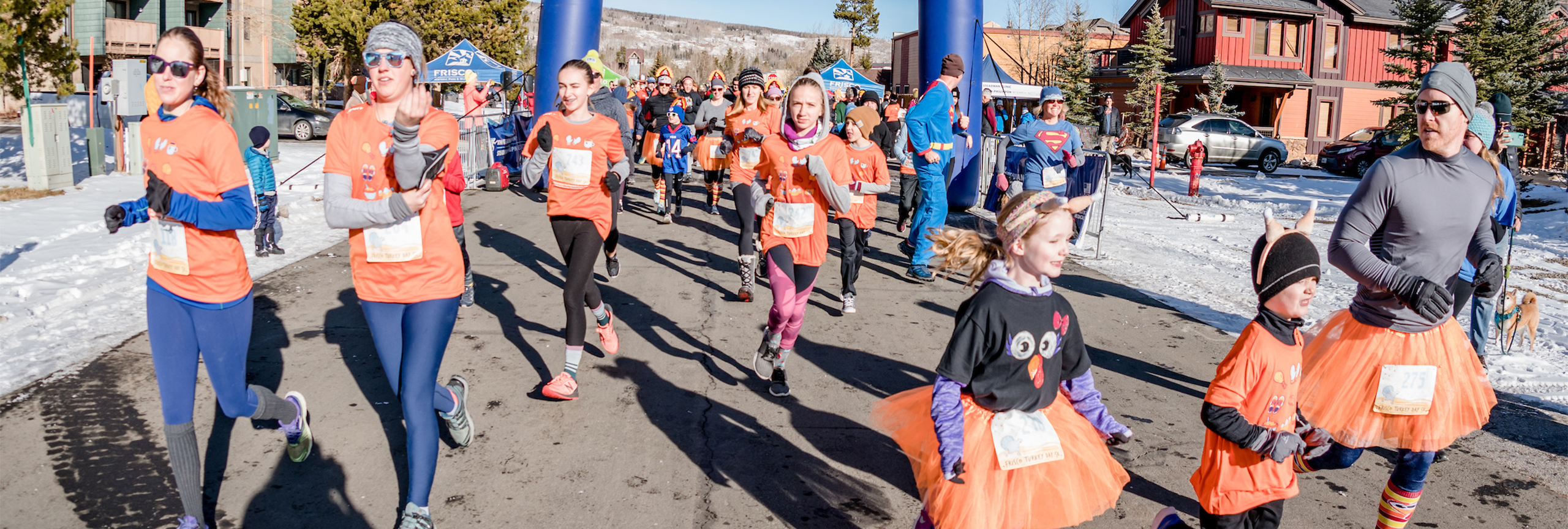 Large group of runners wearing orange at the Turkey Day 5K.