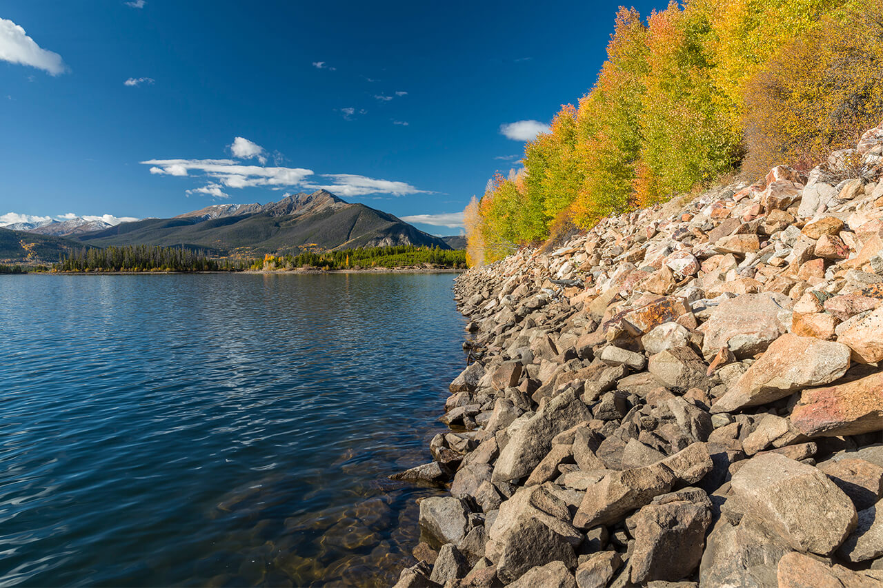 Changing leaves along the shoreline of Lake Dillon with view of Tenmile Range.