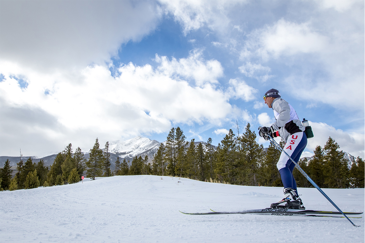 Nordic ski racer with Peak One in background.