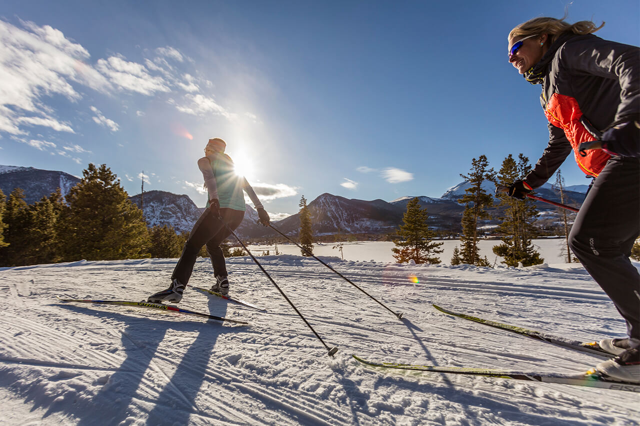 Two women skate skiing at Frisco Nordic Center.
