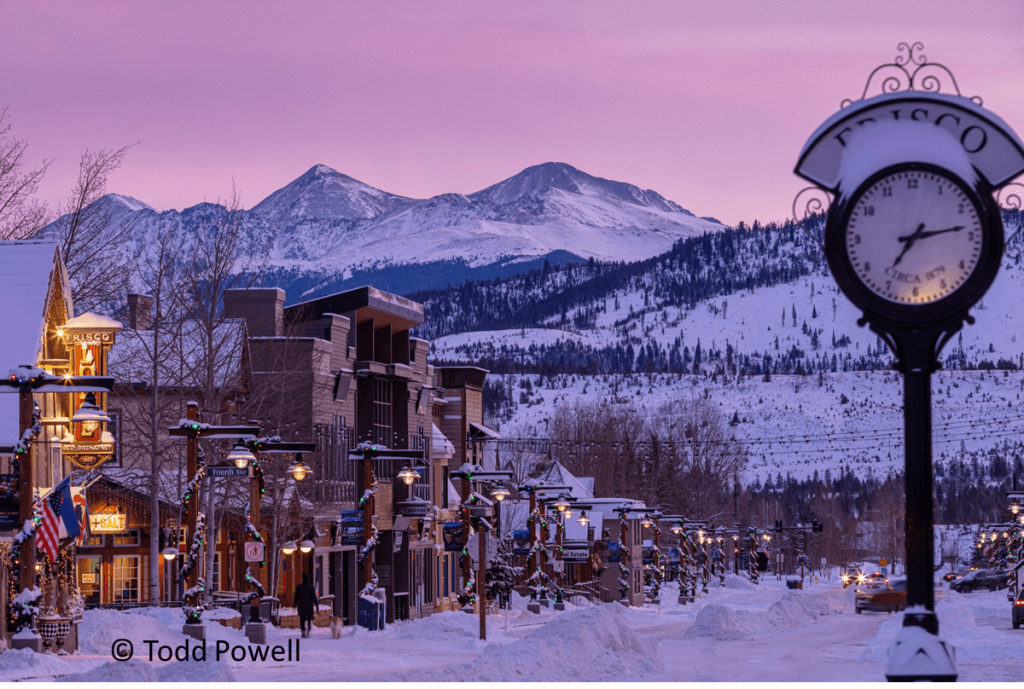 A pink afterglow illuminates this snowy scene of main street, Frisco.