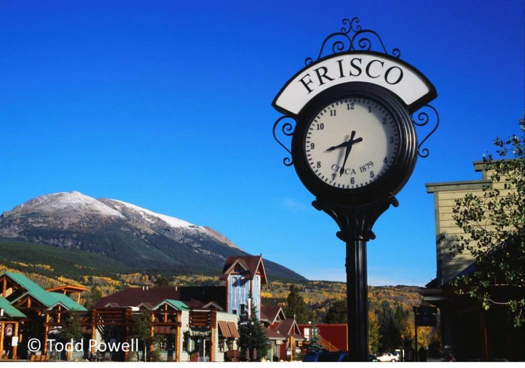 Frisco main street with clock in the foreground and mountains beyond.