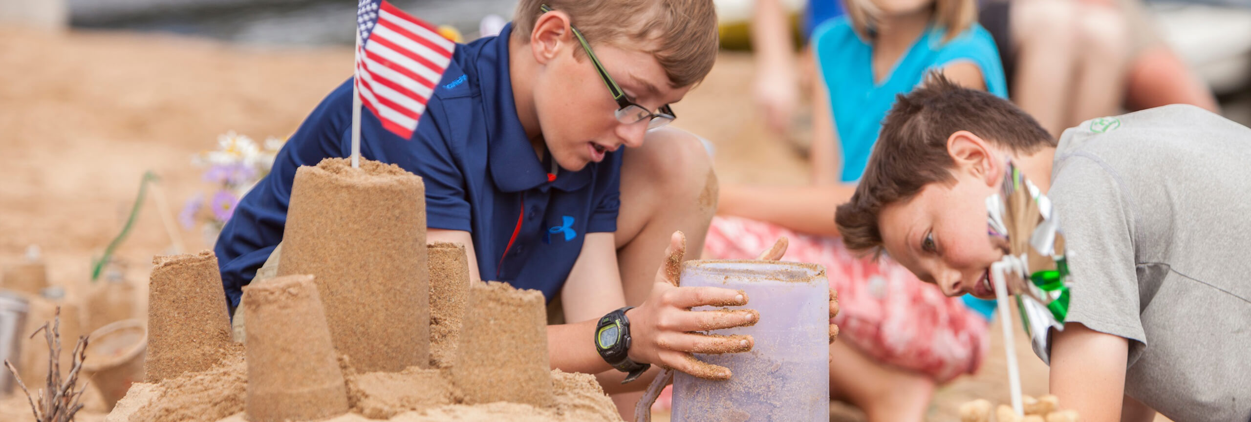 Boys building sandcastle