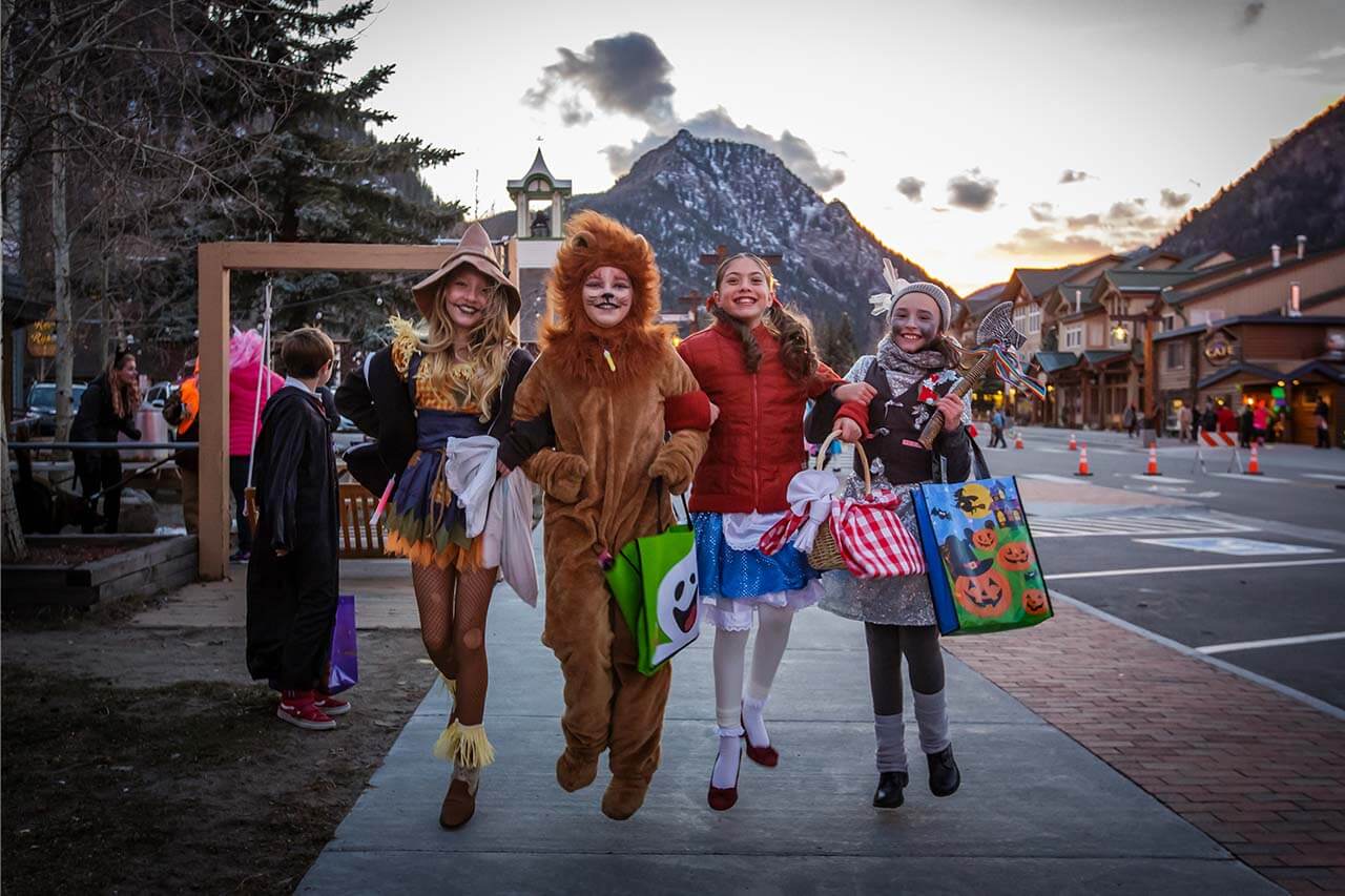 Four girls in Halloween costumes on sidewalk in Frisco