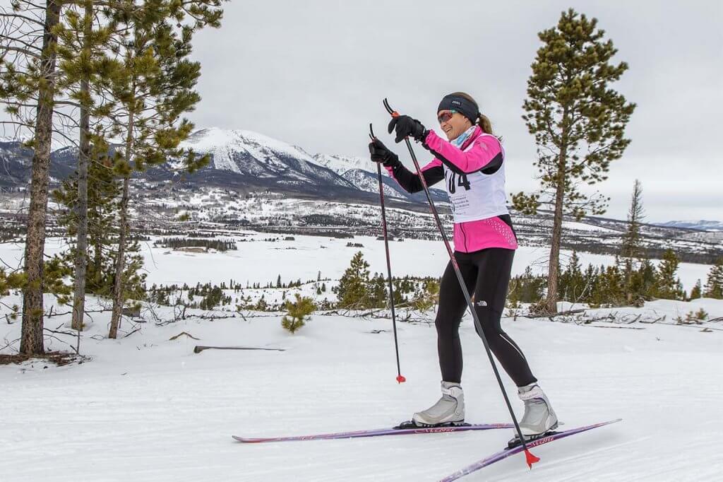 Woman wearing pink top skate skiing at Frisco Nordic Center