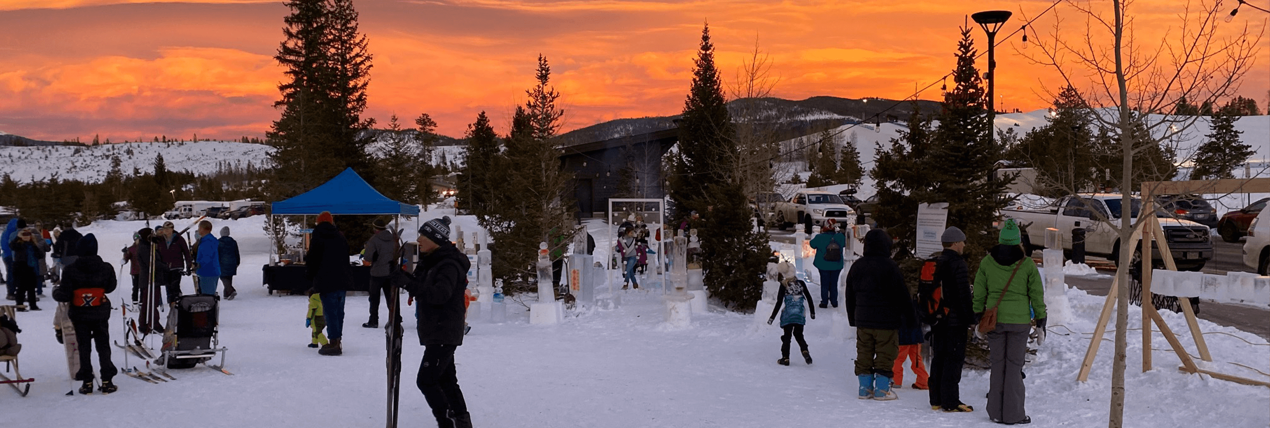 Sunset at the Frisco Nordic Center with people looking at ice displays