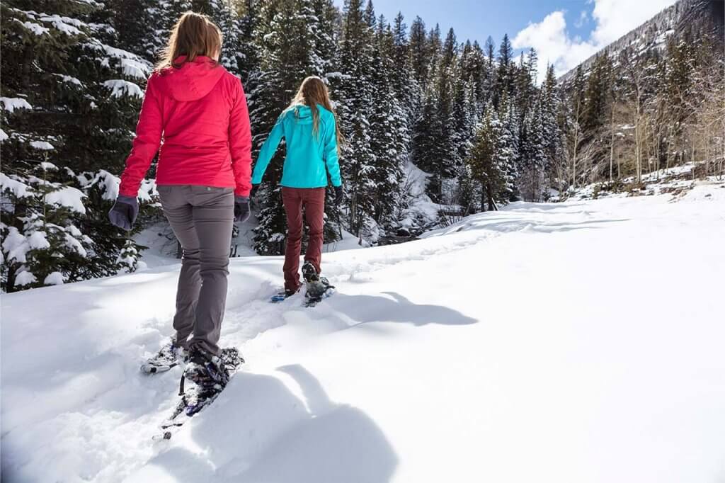 Two women snowshoeing on North Ten Mile trail in Frisco