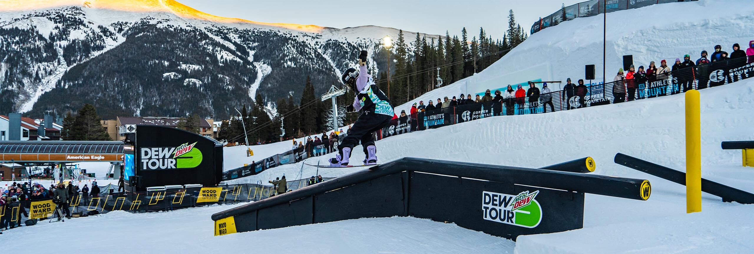 Snowboarder on rail at Dew Tour at Copper