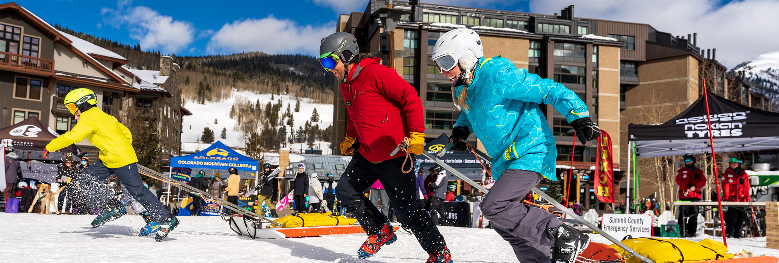 People running with ski patrol sleds at SafetyFest at Copper Mountain