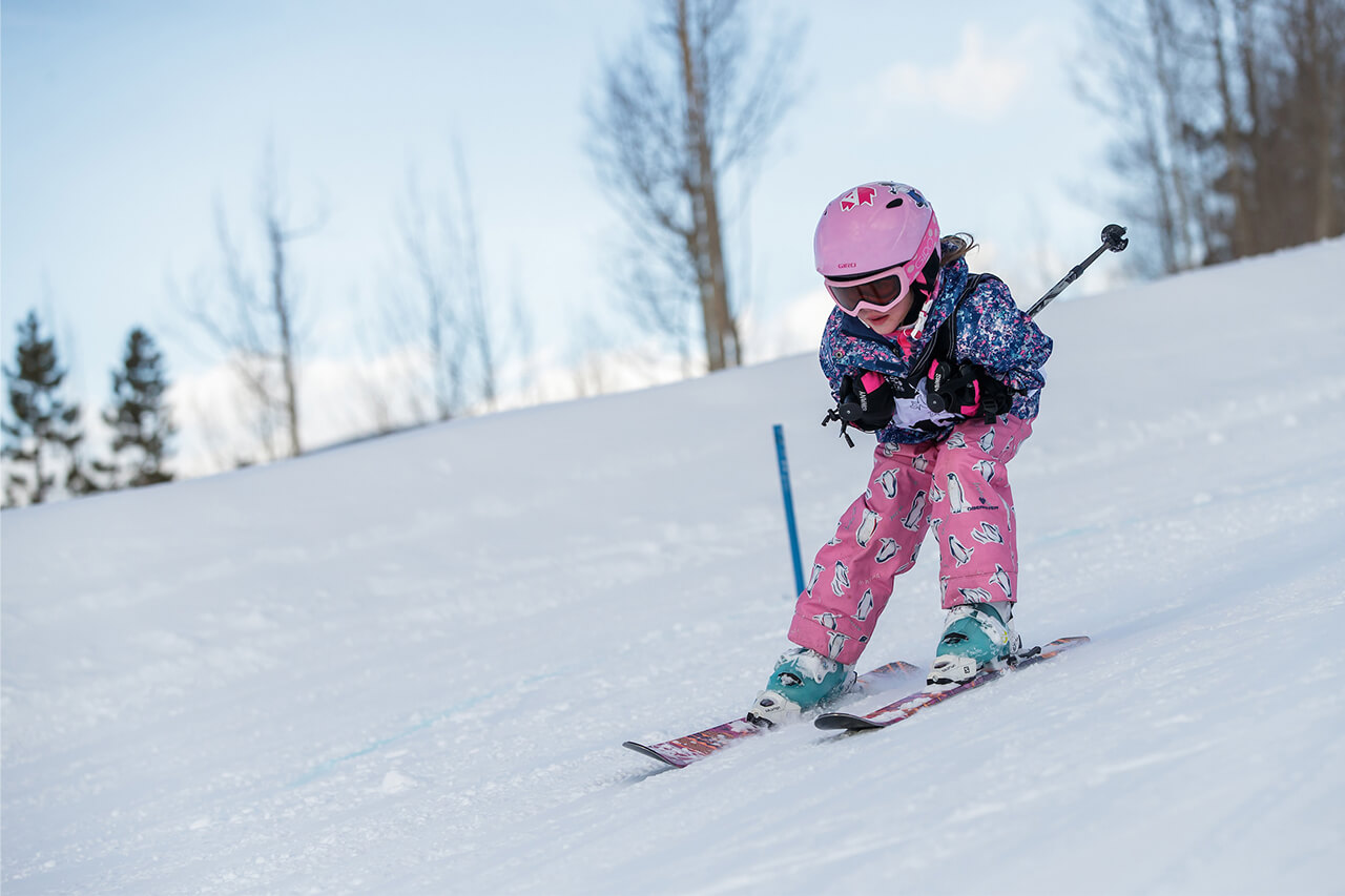 Girl skiing down beginner ski/ride hill at Frisco Adventure Park