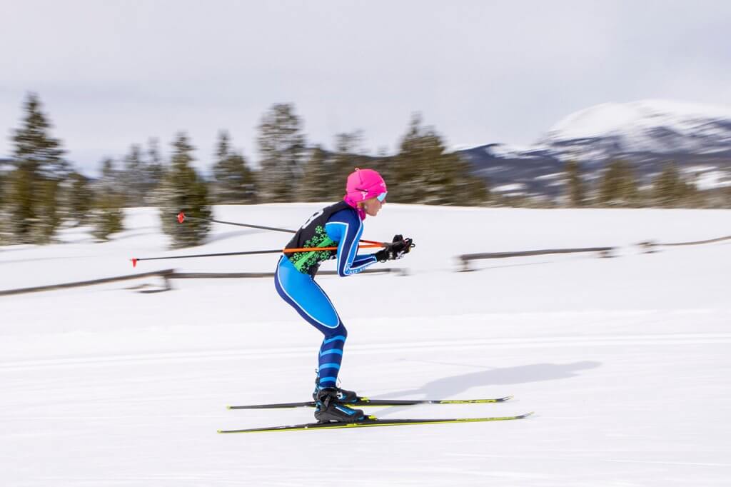 Woman wearing pink hat Nordic skiing at Frisco Gold Rush Nordic Races