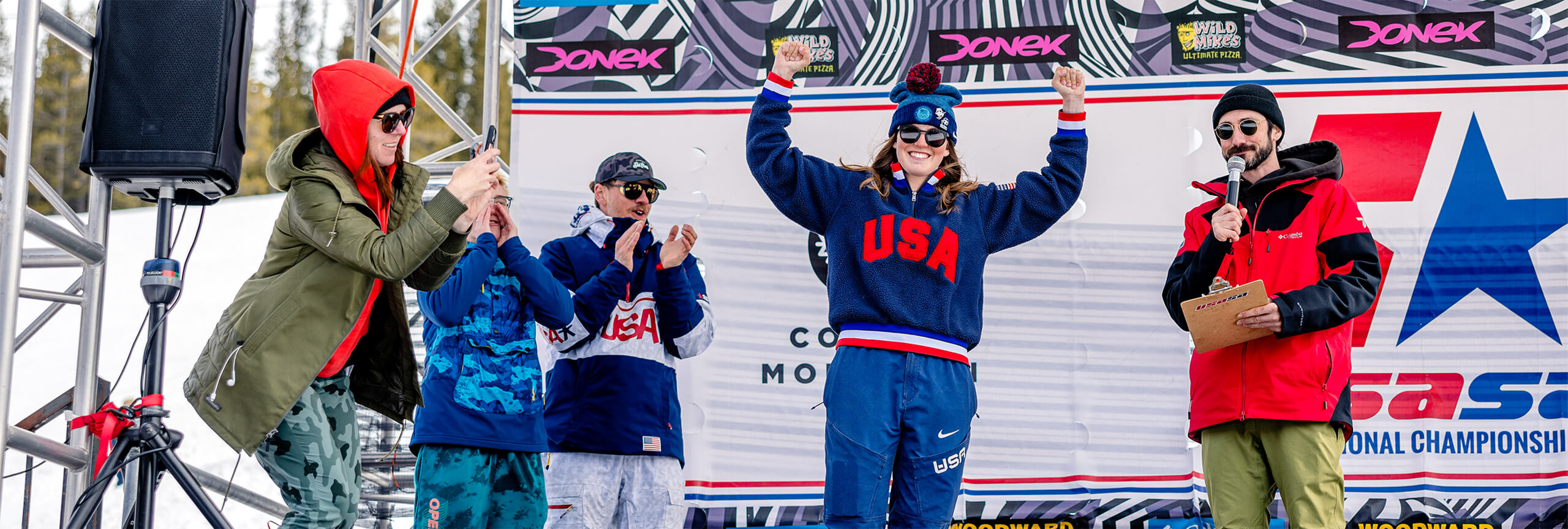 Girl on stage in USA shirt at USASA National Championships at Copper