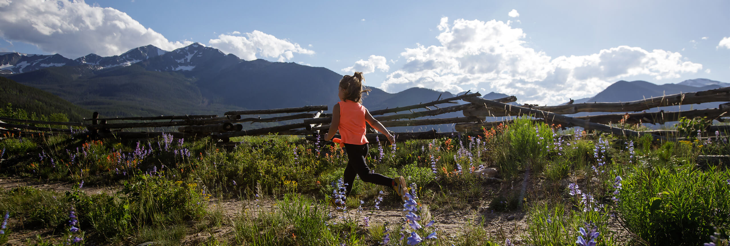 Mountain Goat Kids Trail Running Series. Child running with meadow od flowers