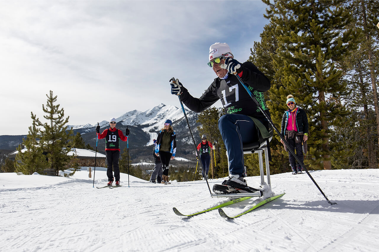 Sit skier on trail at Frisco Gold Rush with people in background
