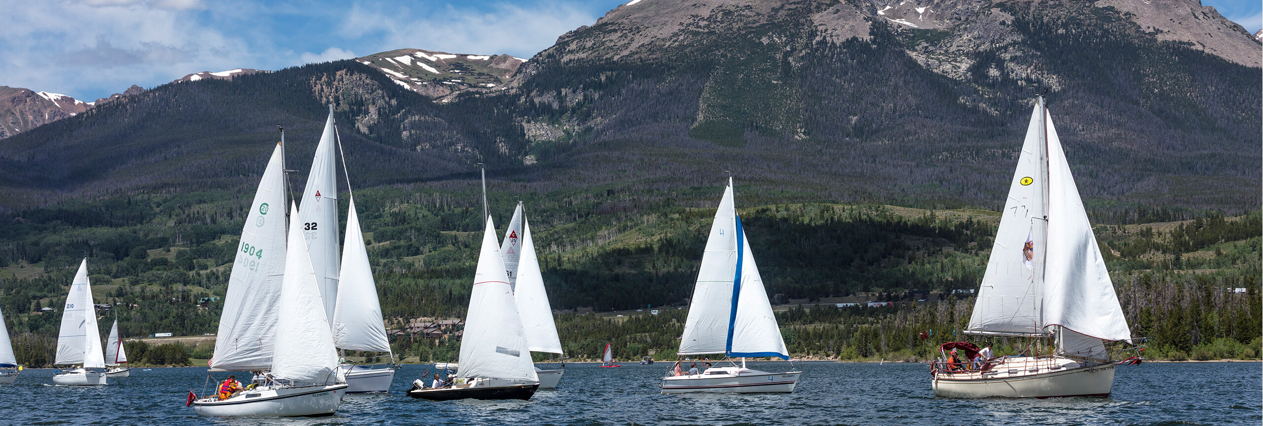 Sail boats during the Timberline Cruiser Regatta in the Dillon Reservoir with Buffalo Mountain in the background
