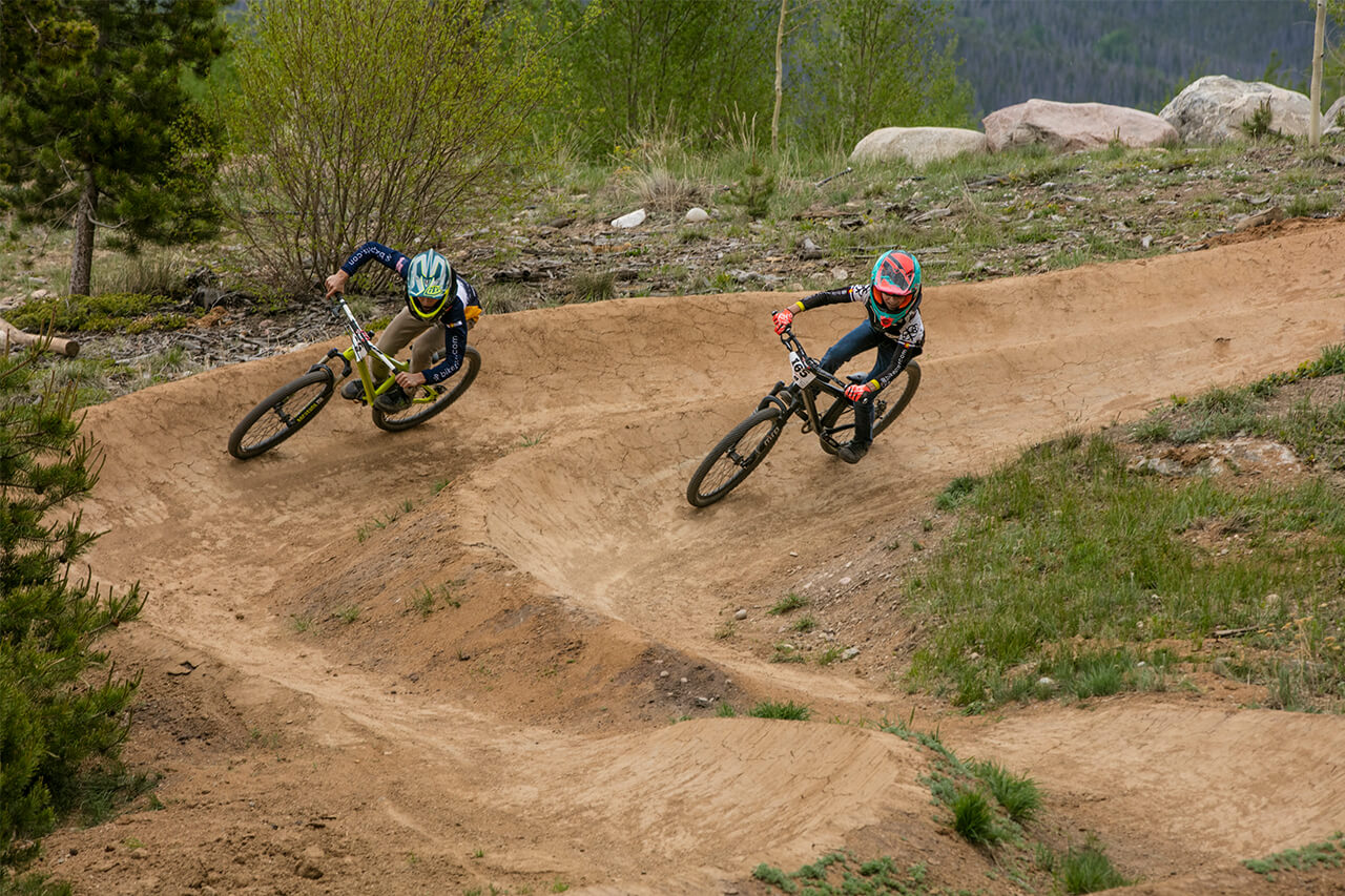 Two mountain bikers racing on dual slalom course at Frisco Adventure Park