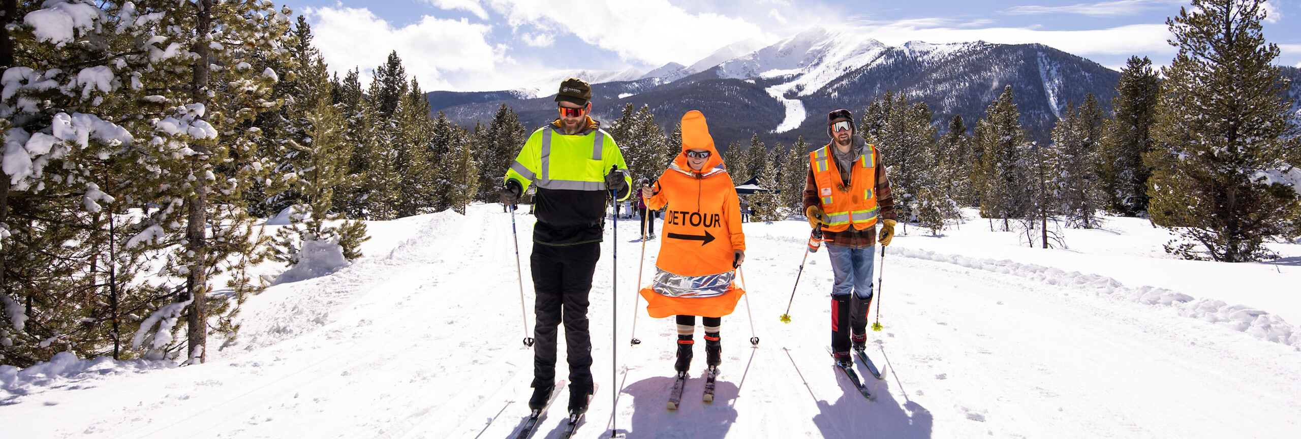 BrewSki costumed participants on the Nordic Trails with Peak One in the background